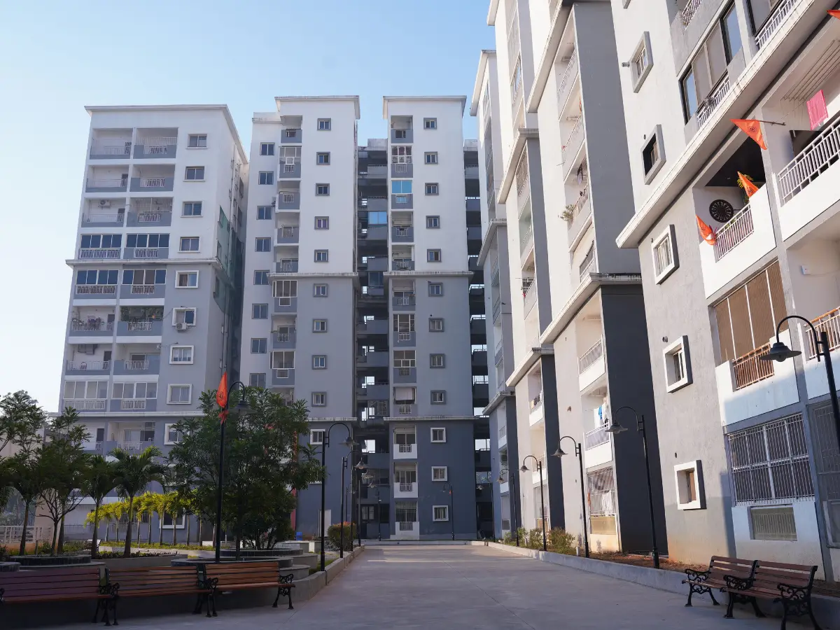 Assisted living for seniors in Kukatpally Hyderabad Telangana — caregiver attending elderly resident in facility courtyard